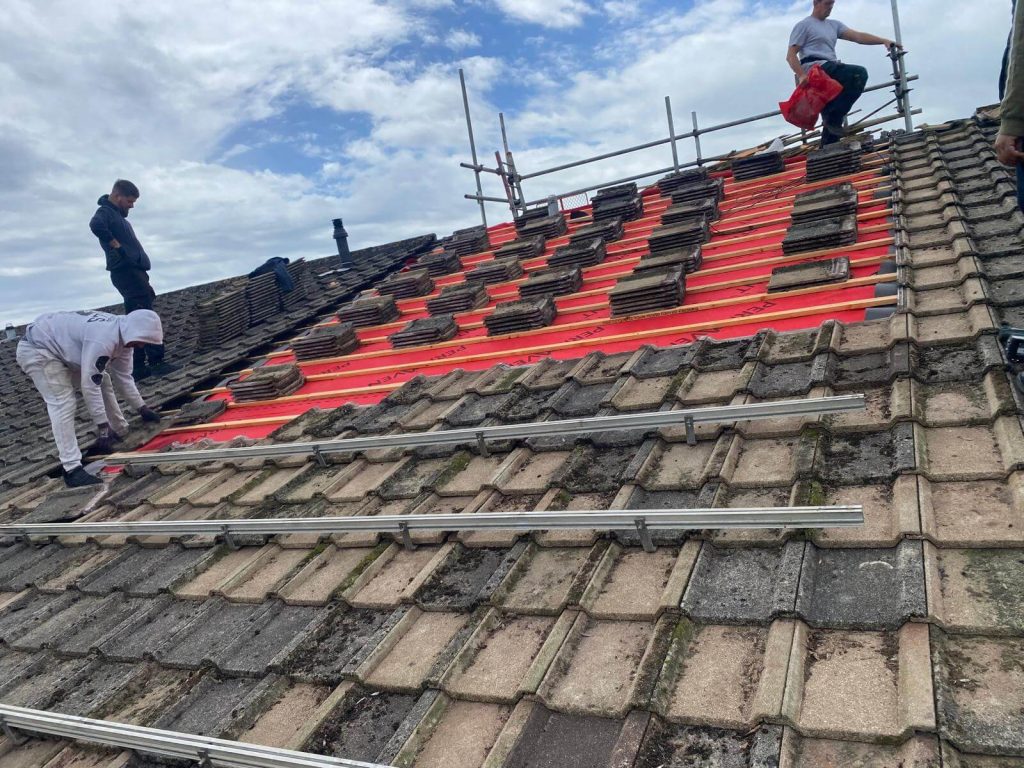 roofers fixing a leak on a roof